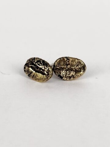 Two golden bronze coffee bean stud earrings with a textured surface, on a white background.