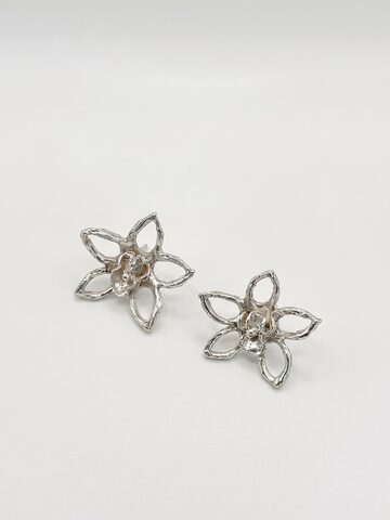 Pair of large silver open five-petal flower stud earrings with small textured blossoms at their centres, on a white background.