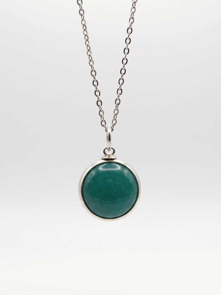 Round teal stone pendant in a smooth silver frame on a fine silver chain, on a white background.
