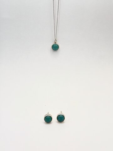 Round teal stone pendant in silver on a fine chain, with matching round teal stud earrings, on a white background.